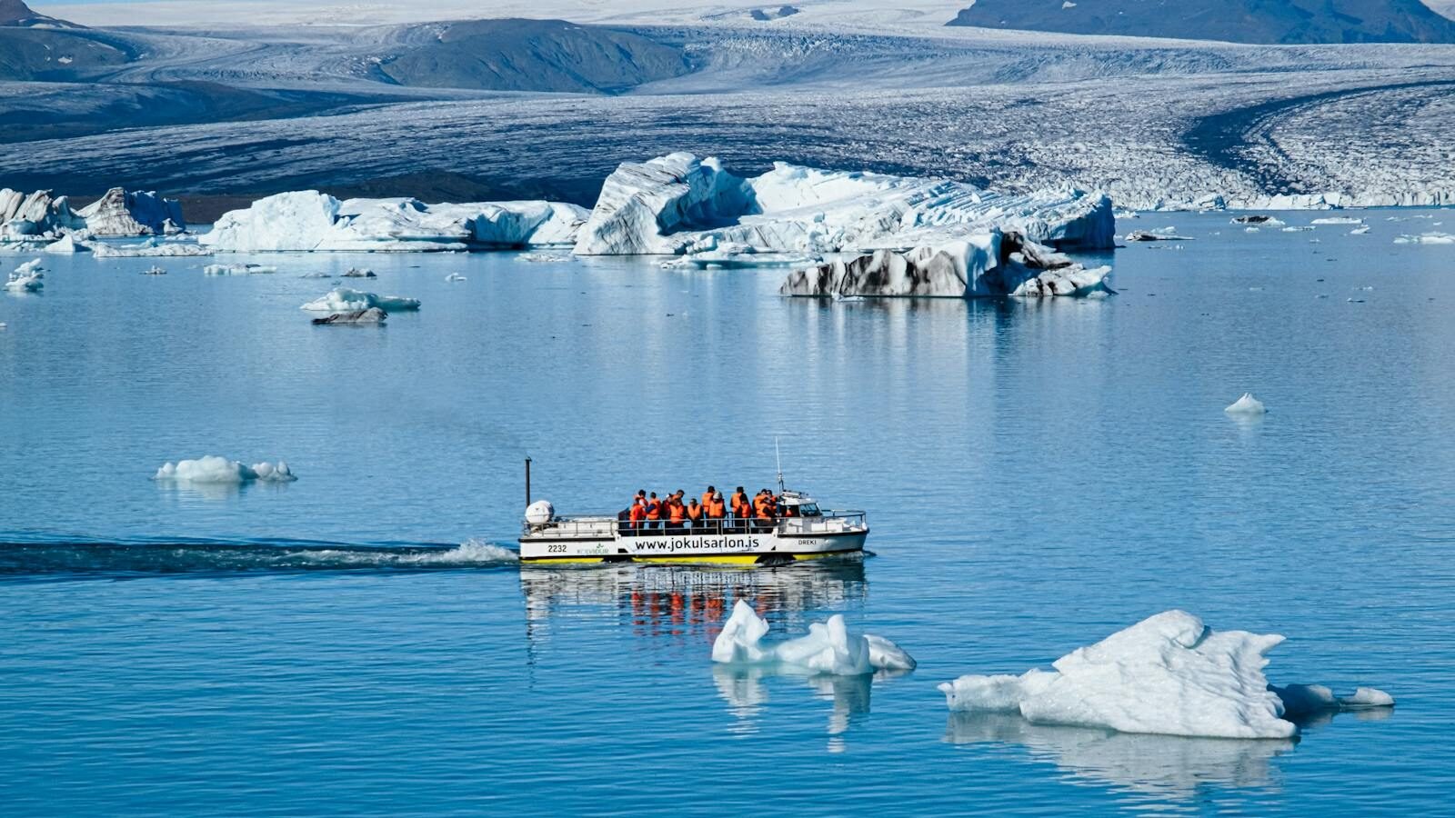 People on Boat in Expedition in Water with Glaciers