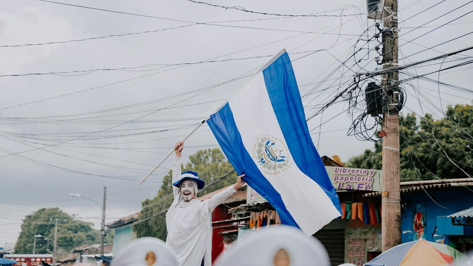 Man Waving an El Salvadoran Flag on the Street